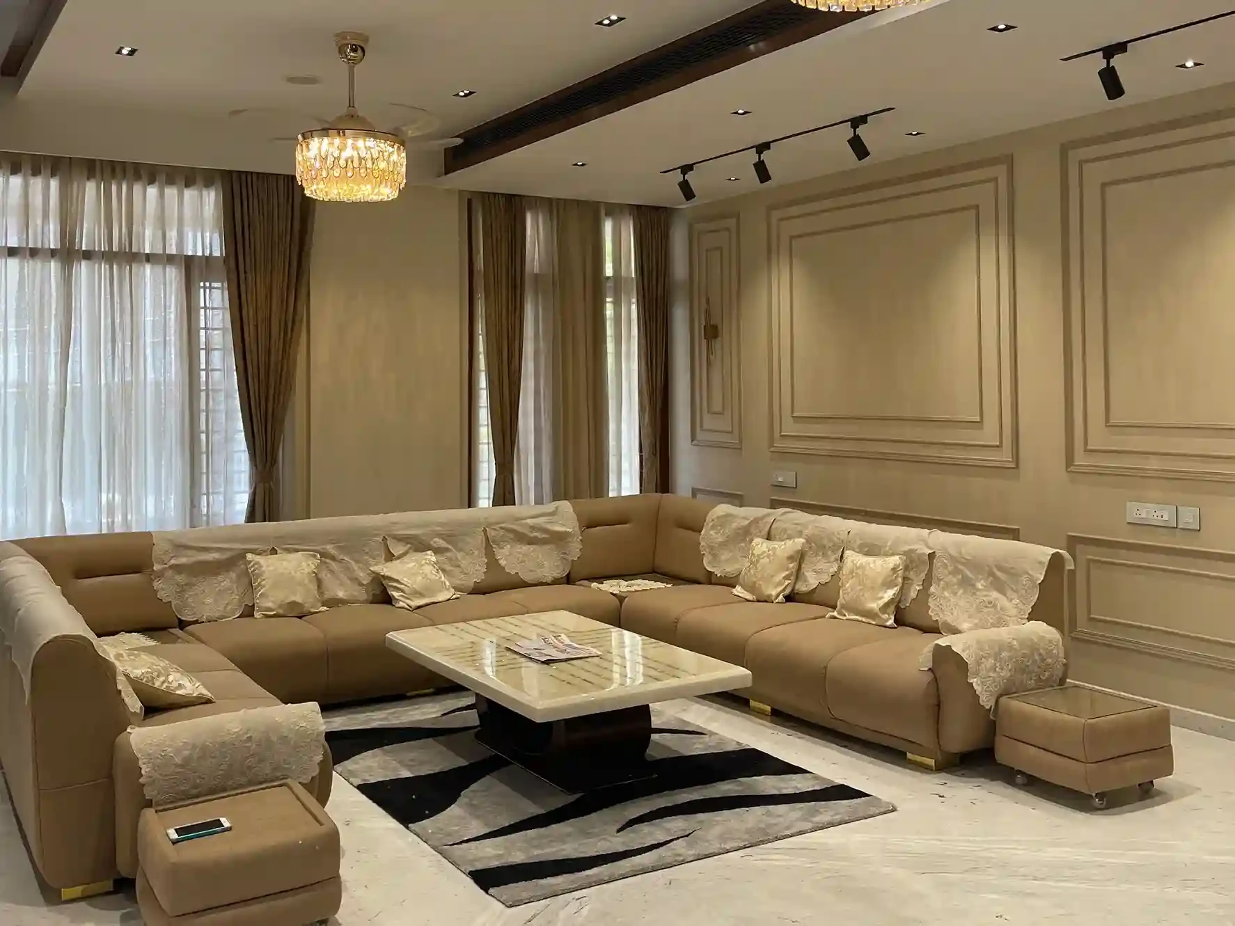Luxury beige living room by Interior Designers Company in Rajajinagar by WeDezine Studio.